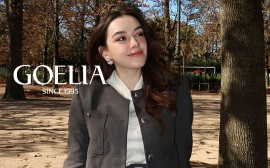 a lady in a white shirt and a grey suit