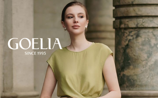 a lady in a green twist waist vest and a pair of white culottes