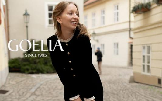 a lady in a ruffle collared black long sleeve dress
