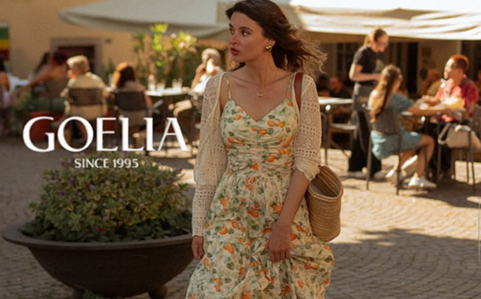 a lady in a green orange printed slip dress and an openwork cardigan